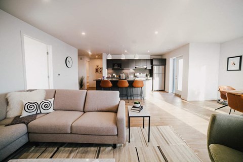 a living room with a couch and a kitchen in the background